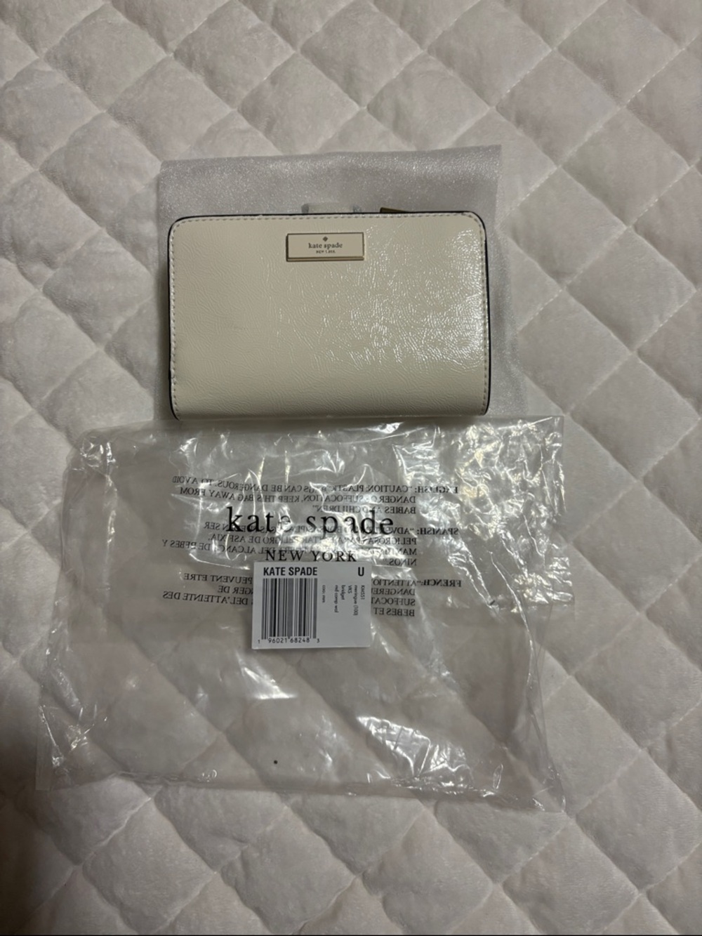 kate spade ivory leather zip-around wallet